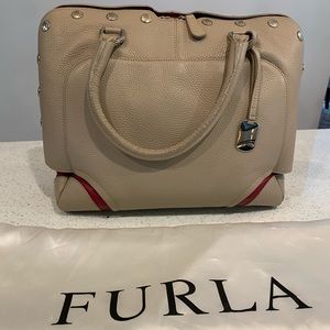 Furla leather handbag with red contrast and snap buttons on the side. Very soft!